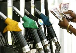 A man counts his money at a petrol pump